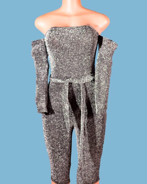 Bodycon Jumpsuit in Silver Glitter Strapless Style This fashion season, look stunning with the off shoulder Silver Glitter Strapless Bodycon Jumpsuit and shine like a diamond. This glittering jumpsuit, with its strapless bodycon shape and tie waist style, is sure to turn heads.