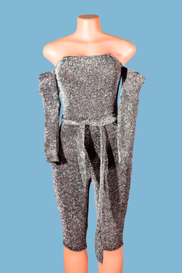 Bodycon Jumpsuit in Silver Glitter Strapless Style This fashion season, look stunning with the off shoulder Silver Glitter Strapless Bodycon Jumpsuit and shine like a diamond. This glittering jumpsuit, with its strapless bodycon shape and tie waist style, is sure to turn heads.